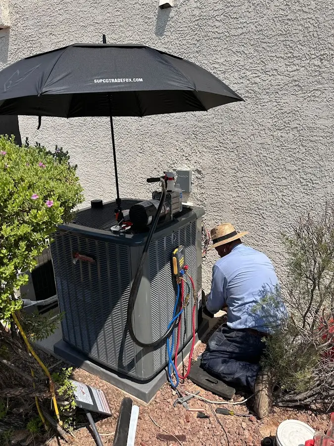 HVAC technician performing outdoor AC maintenance in Hawthorne
